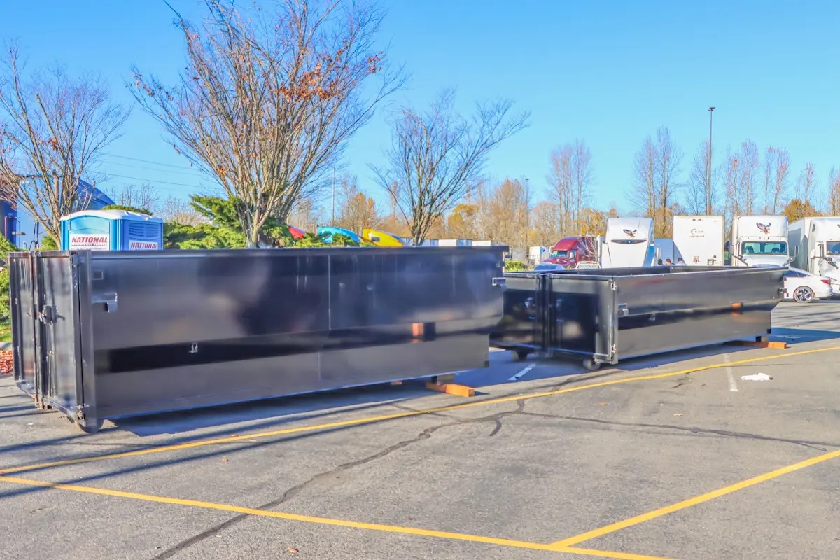 Professional dumpster rental service with roll-off container on residential driveway in Payson